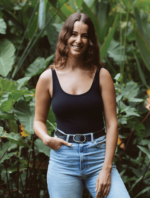 Shoval Hochma standing in front of a wall before a pregnancy massage session