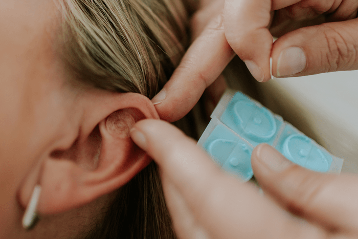 woman using ear seeds in Brisbane
