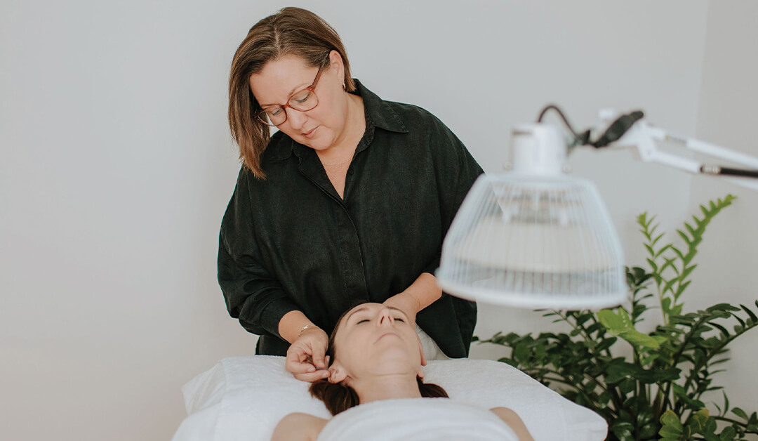 Acupuncturist assisting a woman suffering from menopause in Brisbane